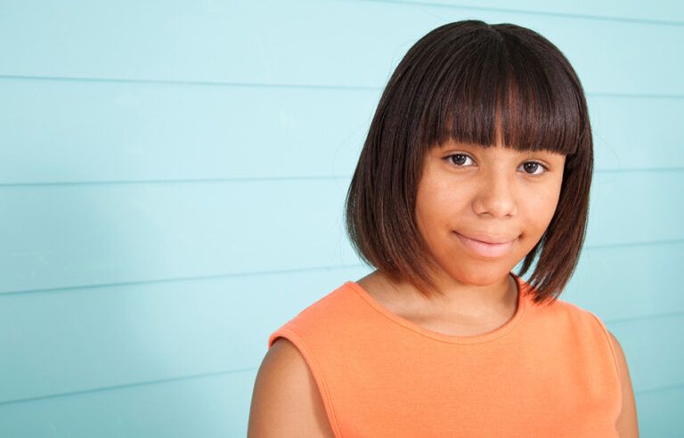 a girl with orange shirt